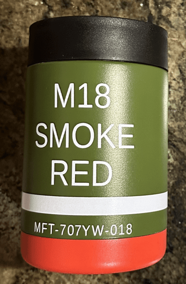 A can of smoke red paint on the side of a wall.